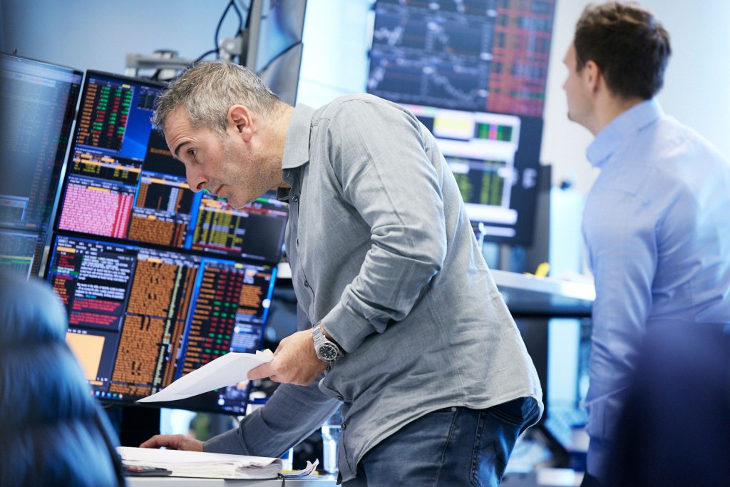 Man looking at multiple screens