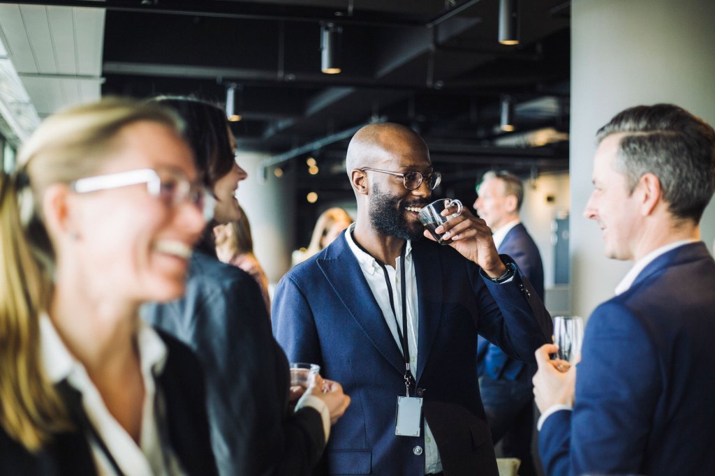 Conferences & Events: Businesspeople interacting at a conference.