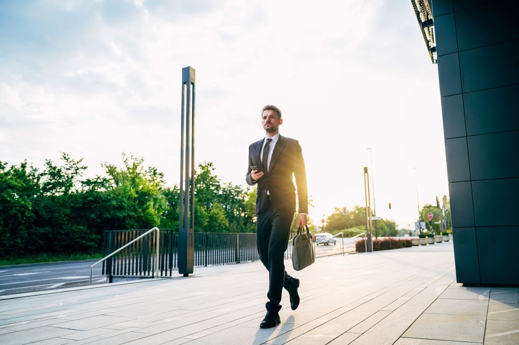 Serious young businessman arriving at work in morning
