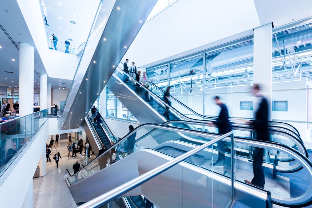 People on elevators in commercial building